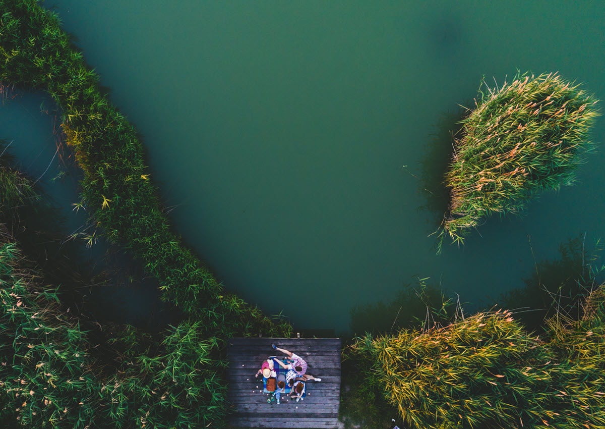 Family sitting on the dock by the water